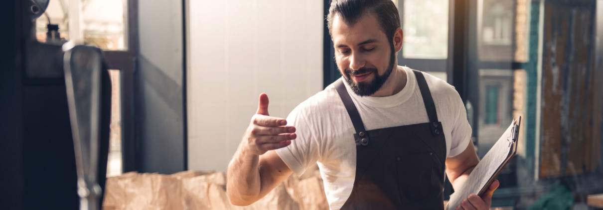 Man smelling coffee in a artisan factory environment