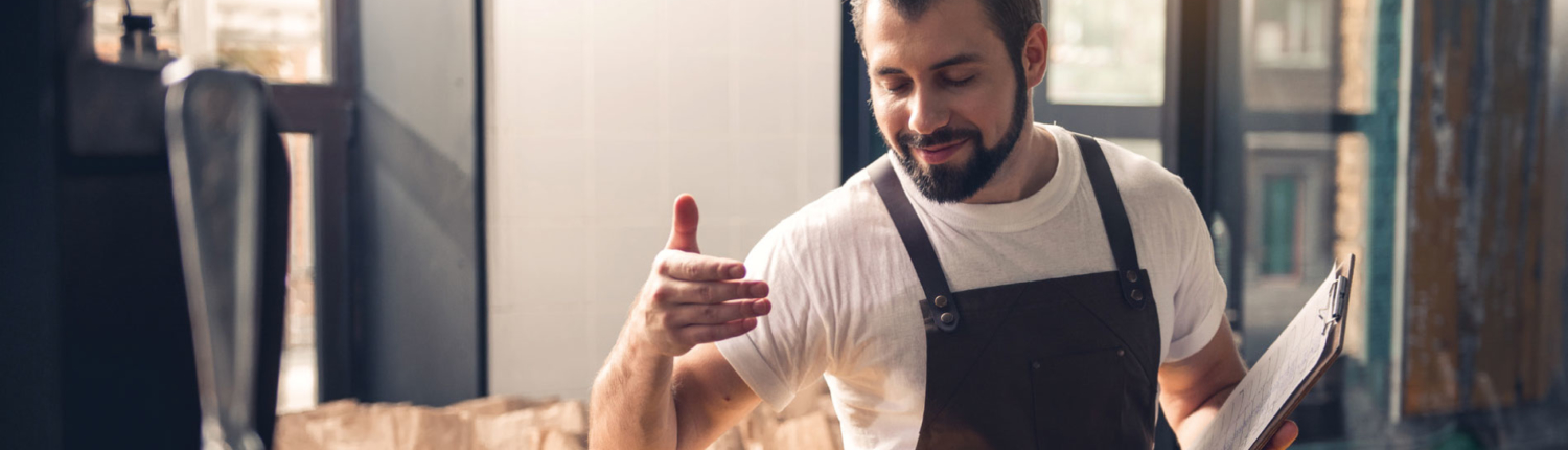 Man smelling coffee in a artisan factory environment