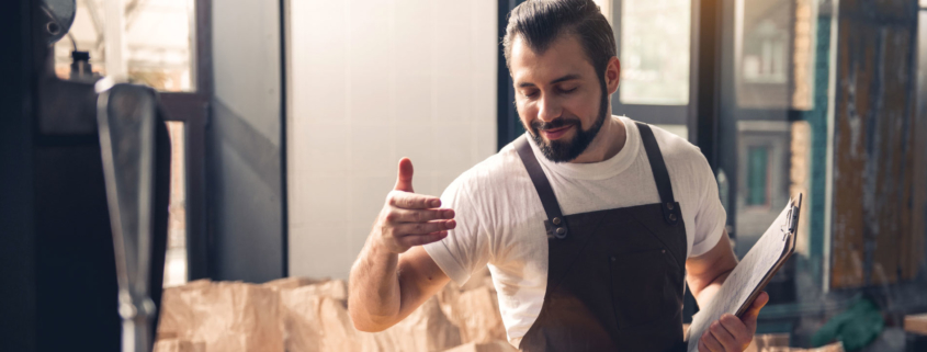 Man smelling coffee in a artisan factory environment