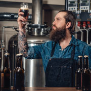 Man examining a glass of beer