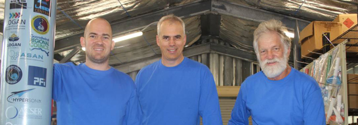 Three employees of Black Sky Aerospace standing together and smiling