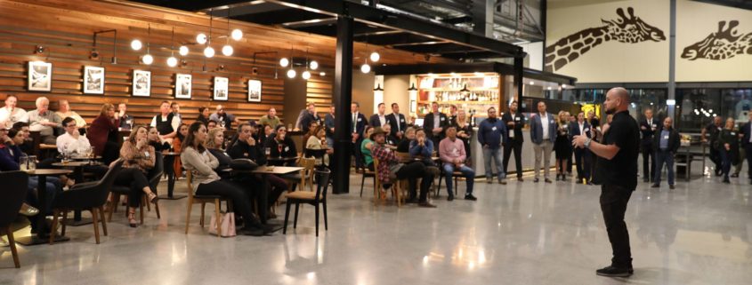 Man presenting to crowd of onlookers at the Distillery Road Market Retailer Preview