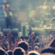 Crowd clapping in front of stage with musicians performing