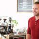 Man and woman smiling at each other in a cafe