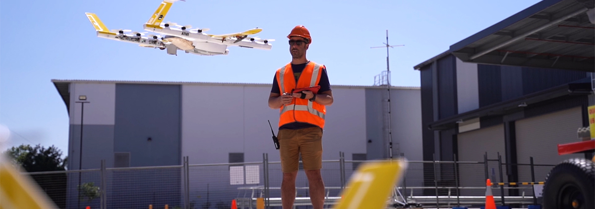 Man flying a drone outside a commercial property