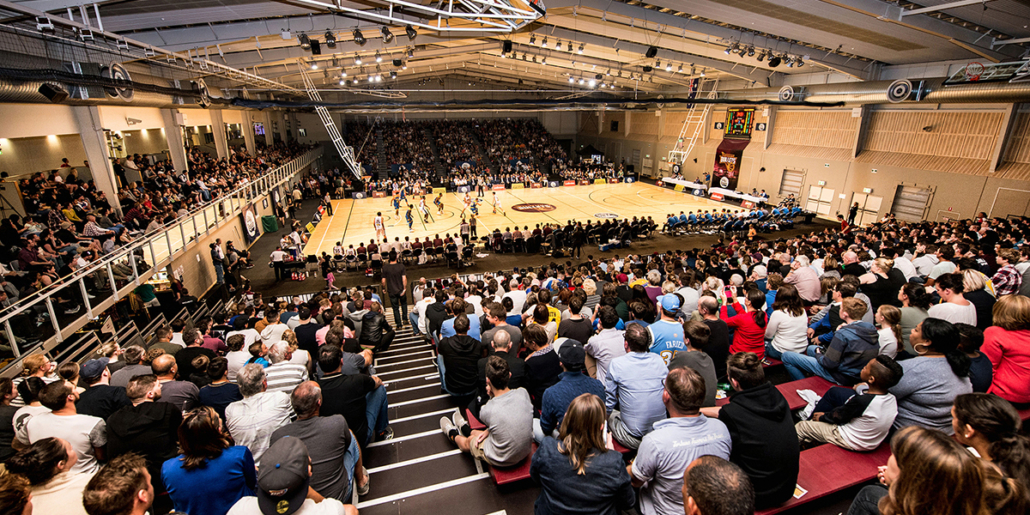 Crowd watching an indoor basketball game