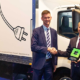 Woman smiling and two men shaking hands in front of a IKEA truck