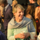 Smiling women having a conversation in a crowd of people