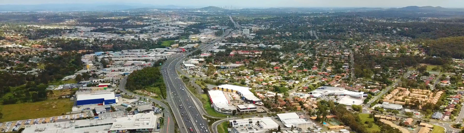 Aerial photo of Slacks Creek, Daisy Hill and Springwood with Brisbane in the distance