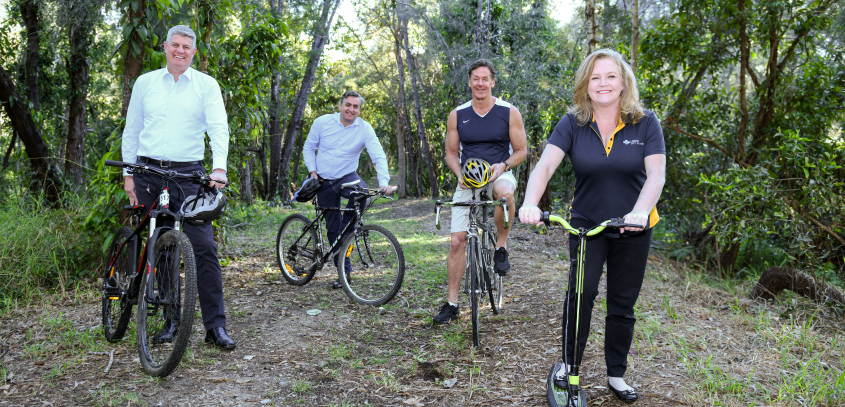 This is a picture of four people at the the location of the future rail trail.