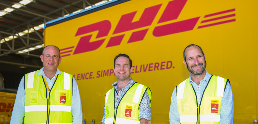 men in front of DHL truck in warehouse