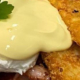 A breakfast of bacon, egg, hash browns and hollandaise sauce with toast