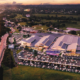 Aerial photo of Distillery Road Market next to motorway, with artist render of markets