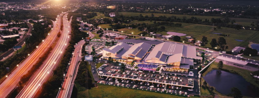 Aerial photo of Distillery Road Market next to motorway, with artist render of markets