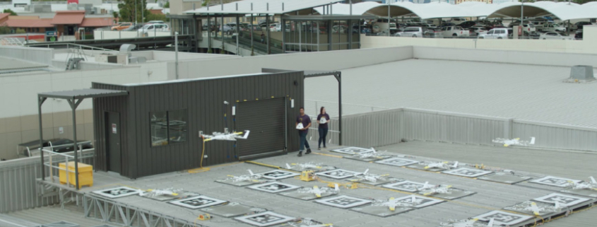 Wing drones launching from shopping centre roof