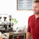 man serving woman at a cafe