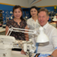 City of Logan Mayor Darren Power gets some sewing tips from machinists Charlene Kim (left), of Kuraby, and Annabella Lewis, of Marsden.