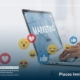 Image_Social Media icons on screen and a marketer using a laptop