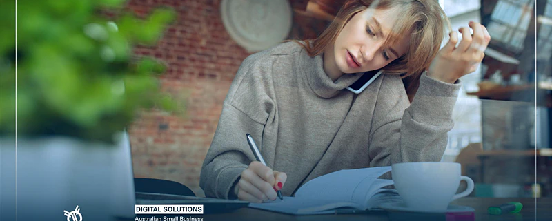 A business woman on phone and taking notes