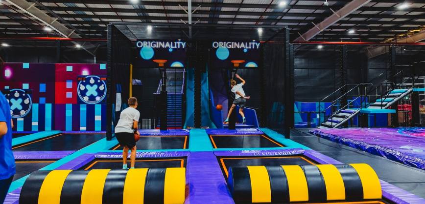 Children play trampoline basketball at Area 51