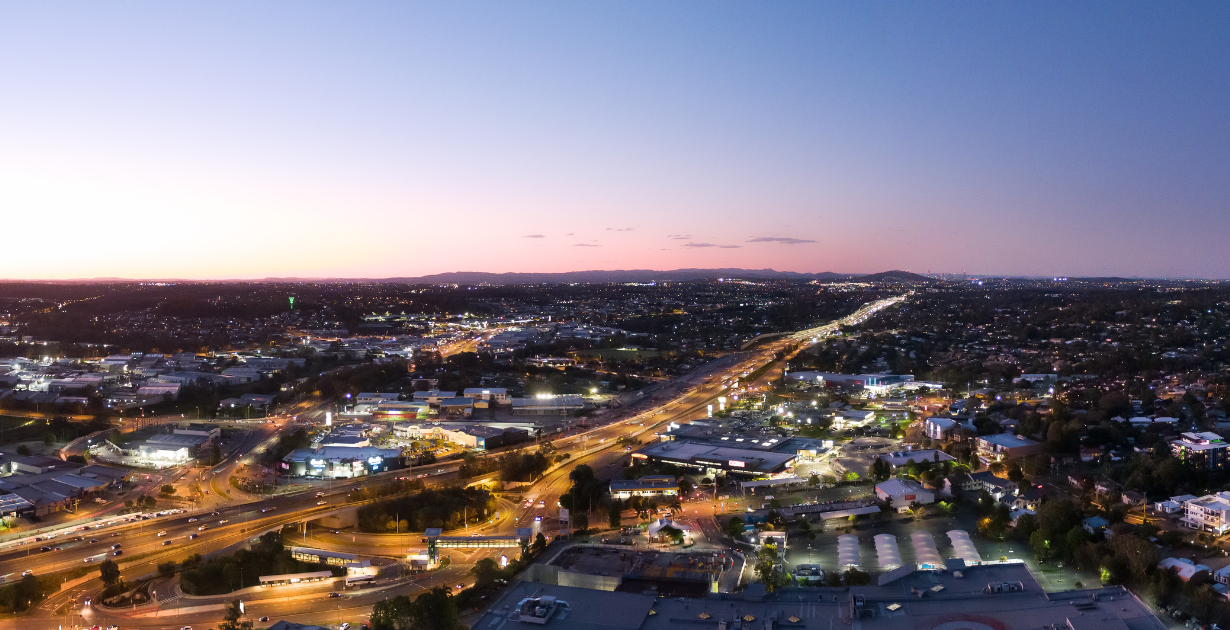 Evening drone photo of Springwood and Underwood looking northbound on the M1 Motorway