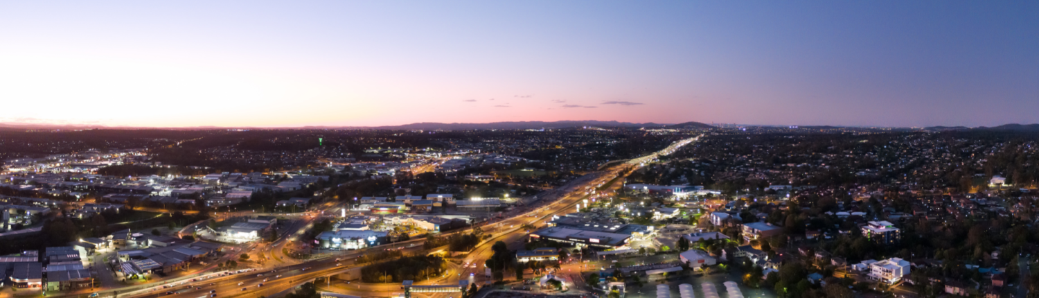 Evening drone photo of Springwood and Underwood looking northbound on the M1 Motorway