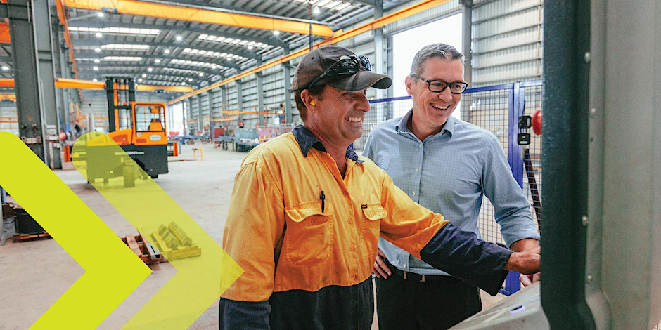 Image_A tradie showing a supervisor the manufacturing machine
