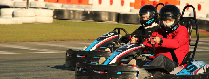 2 people driving race cars