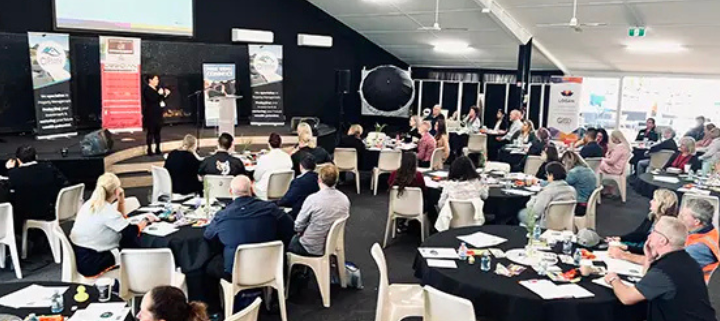 A group of people sitting at a conference