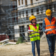 2 colleagues on site inspecting with high-vis vest and helmet