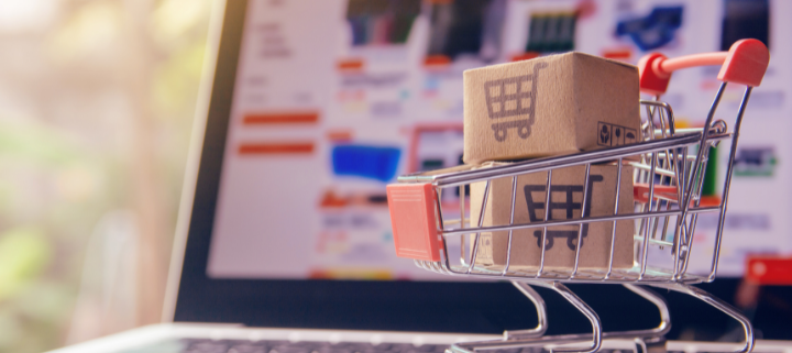 a shopping cart in front of a laptop