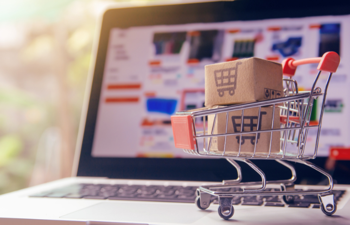 a shopping cart in front of a laptop