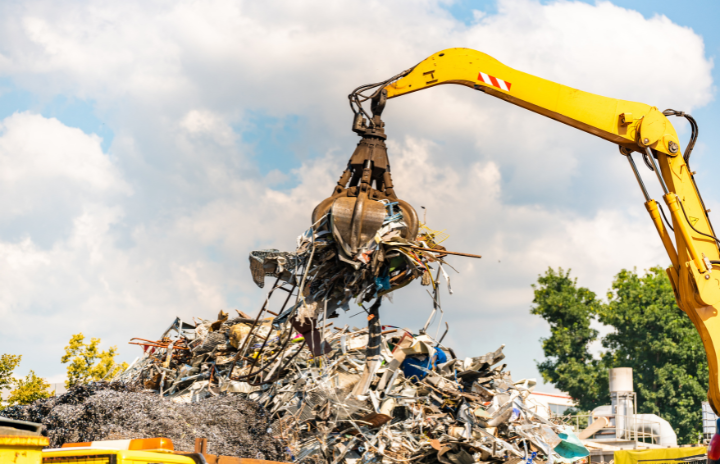 A heavy machine lifting recycled industrial business resources