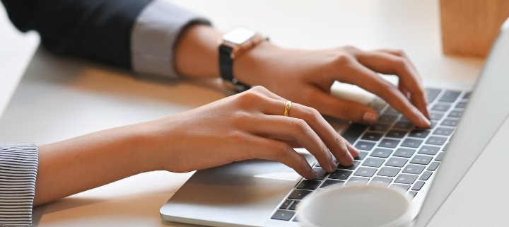 a person typing on laptop