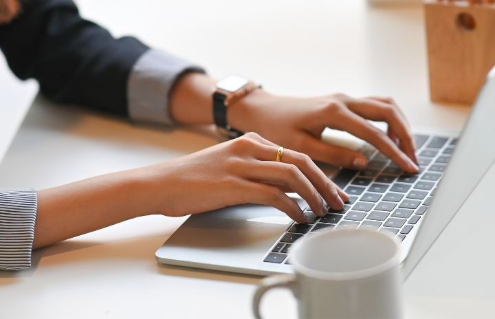 a person typing on laptop