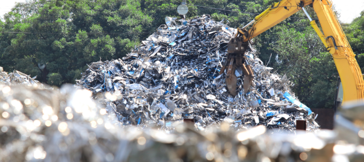 A digger picking up industrial waste