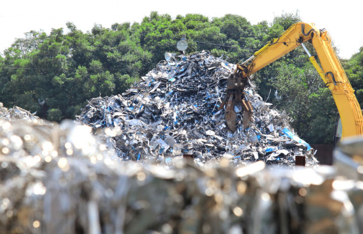 A digger picking up industrial waste