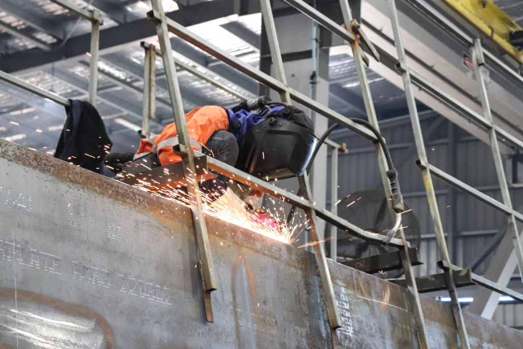 a person in safety gear melding metal