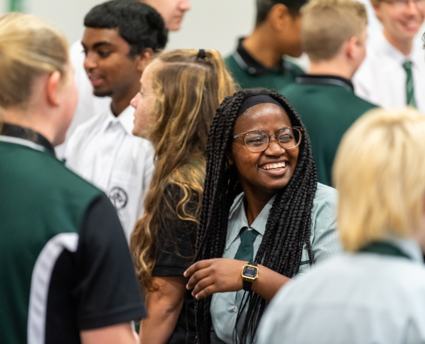 A female student smiling at another student