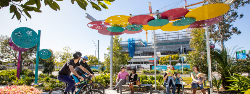 Group of diverse people using the seating and path on Loganlea Road