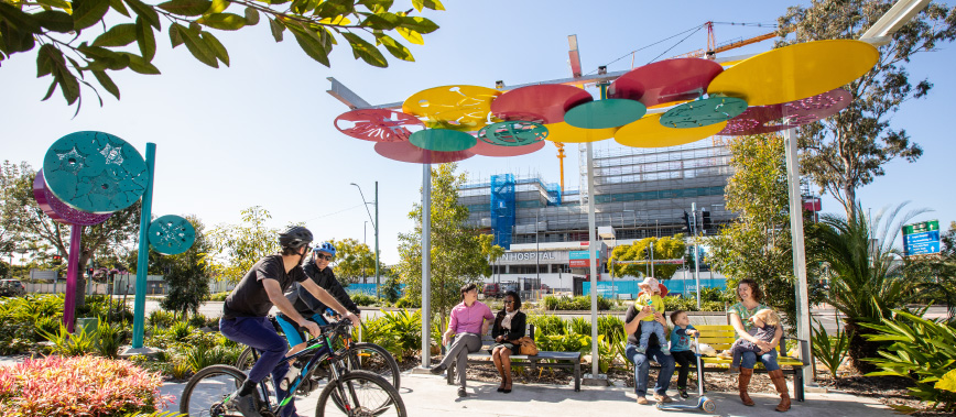 Group of diverse people using the seating and path on Loganlea Road