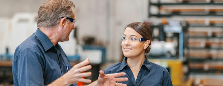 man and woman in workshop talking