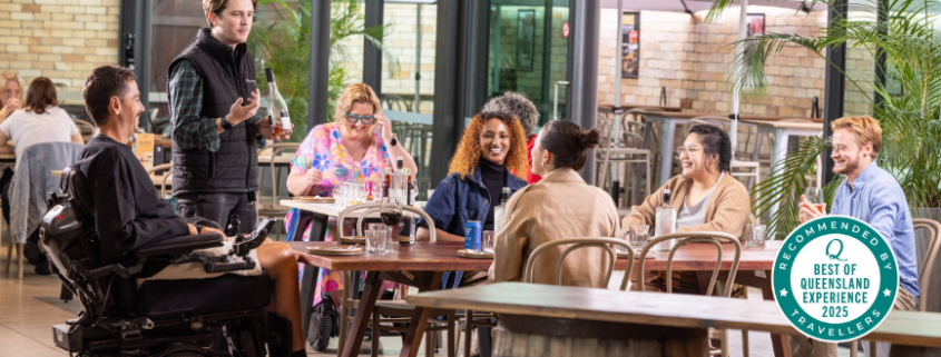 a group of people including people with disabilities dining at Beenleigh Artisan Distillery