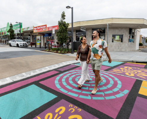 Couple holding hands crossing Croydon Road