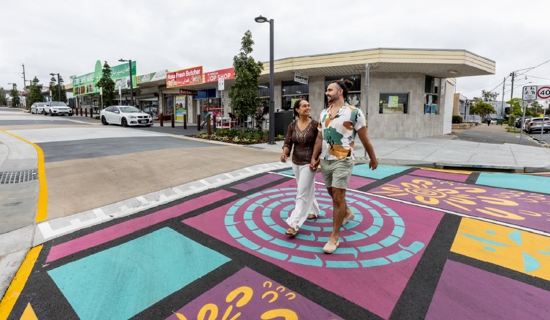 Couple holding hands crossing Croydon Road