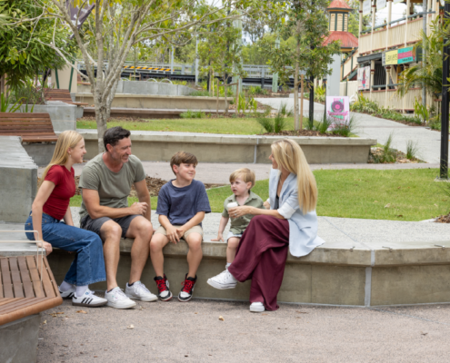 Family sitting on a bench on Cusack Lane Streetscape