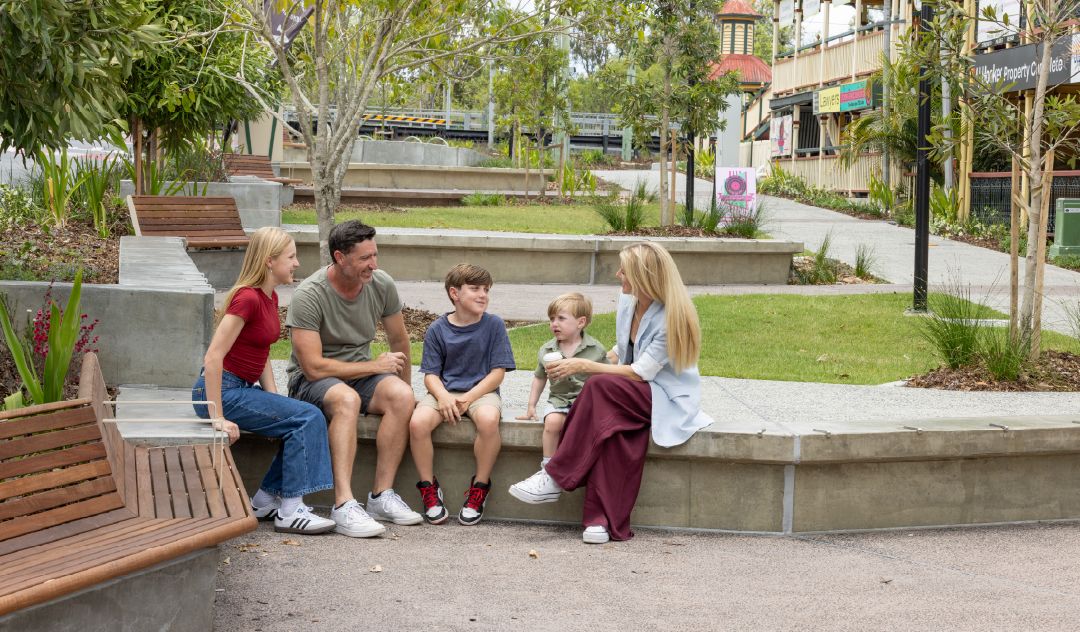 Family sitting on a bench on Cusack Lane Streetscape