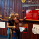 Couple walking and looking through the history wall at Beenleigh Artisan Distillery