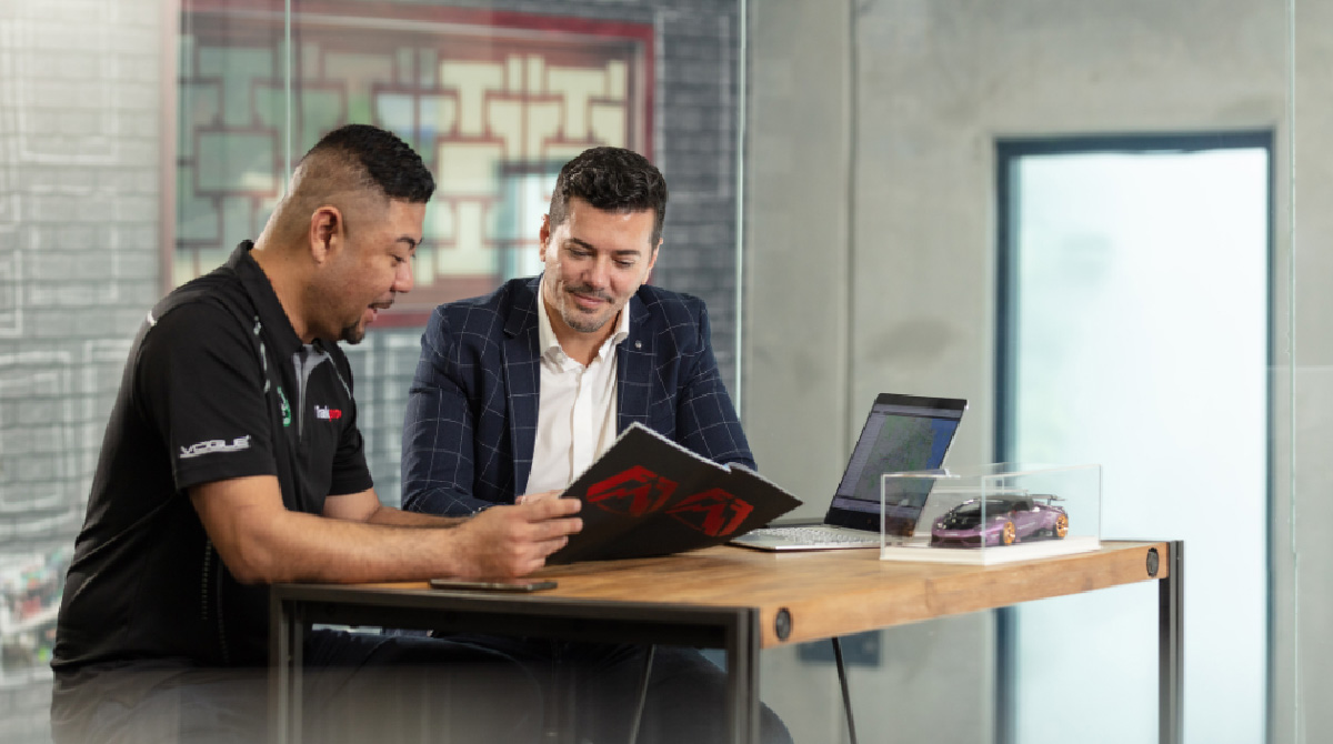 Small business owner talking to a council staff while looking at a document